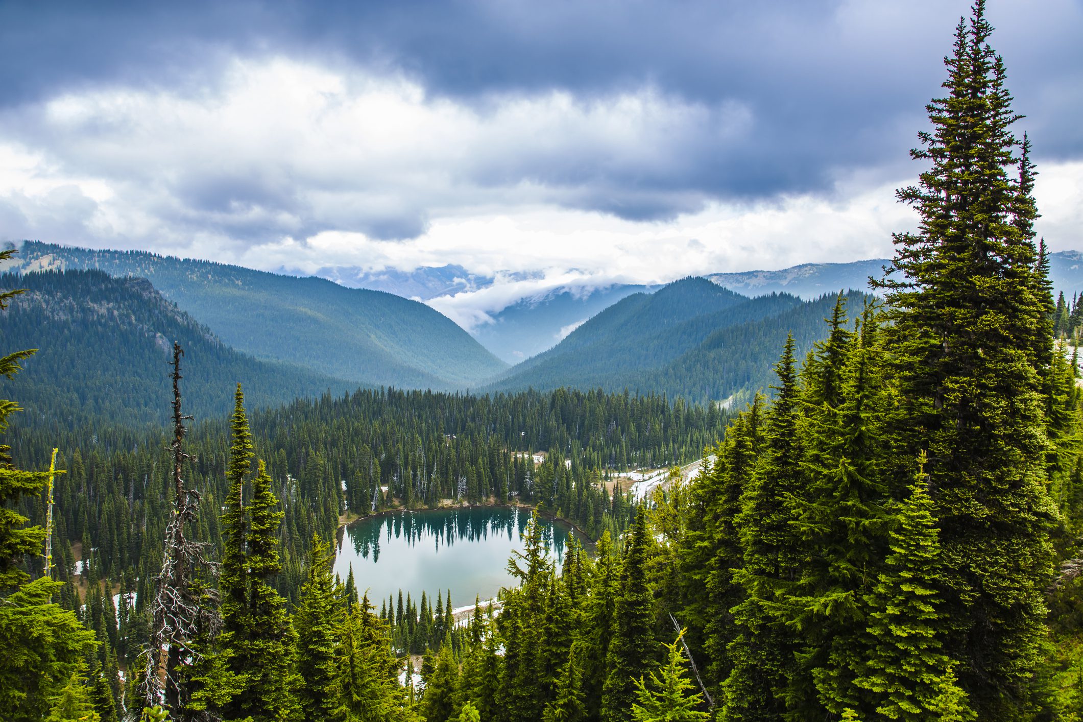 Cloudy sky over forested mountain scene
